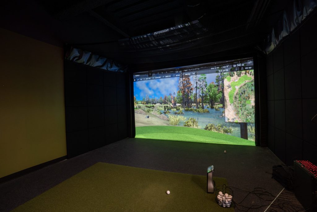 Golf simulator in office game room. 