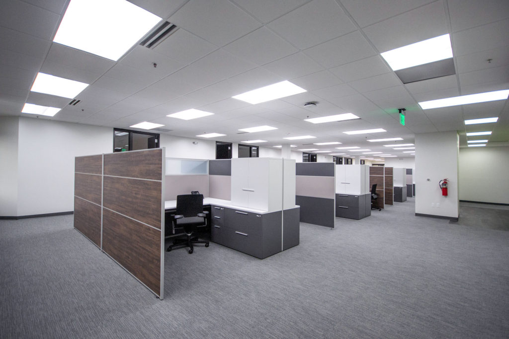 Individual workstations separated by tall partitions.