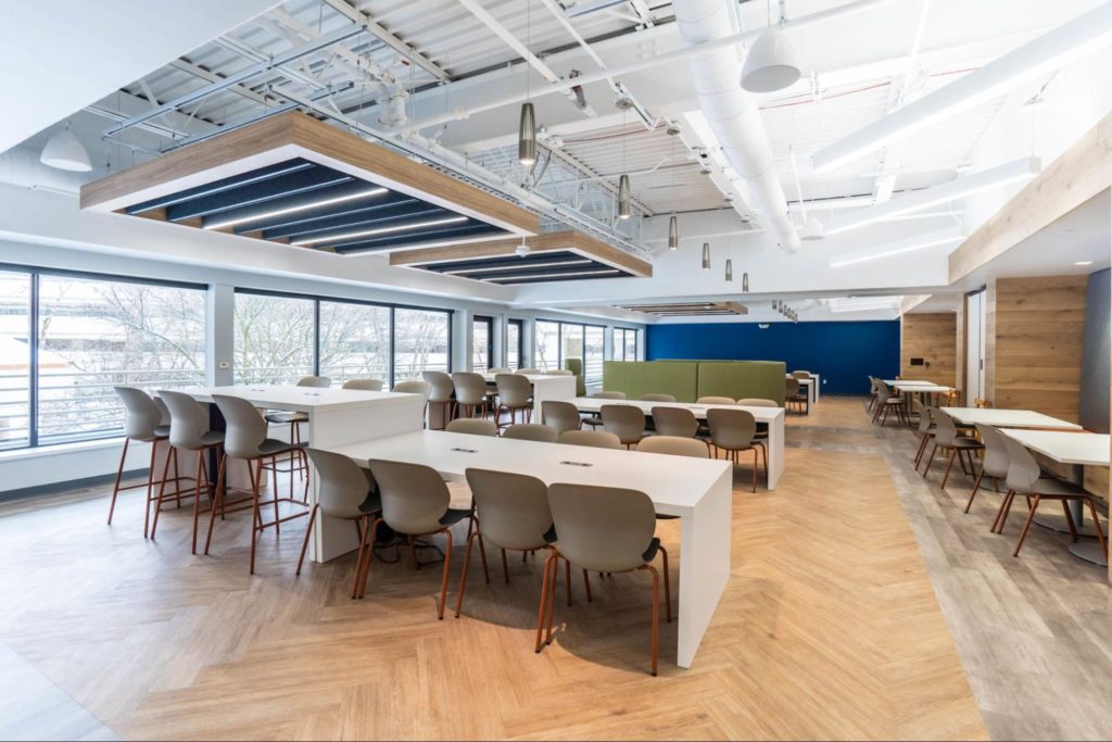 Acoustic panels suspended above tables in an office.