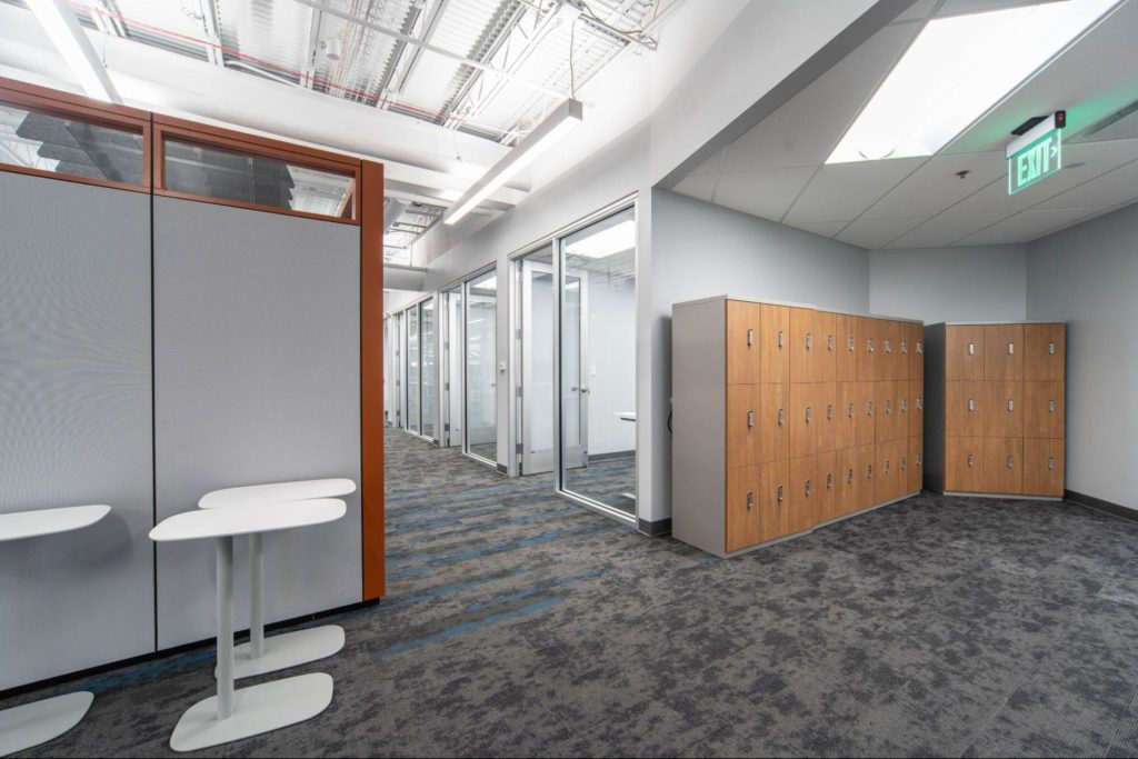 Lockers with wood fronts in the corner of an office.