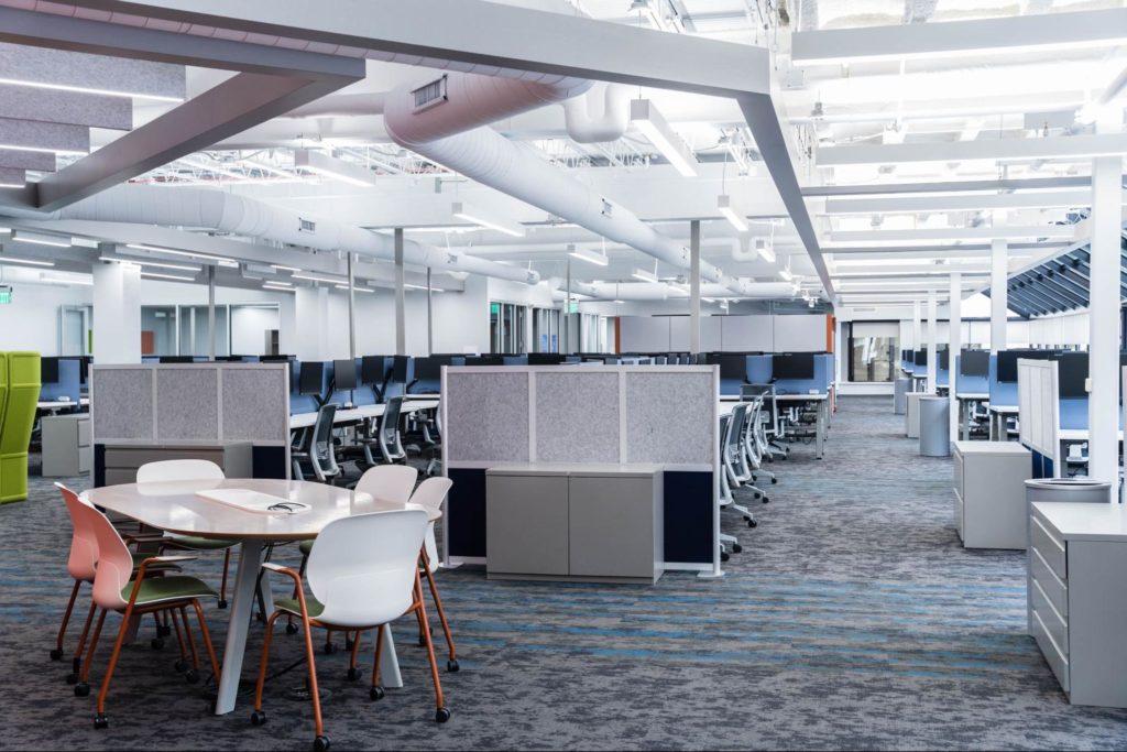 Open office environment with a variety of workstations and collaborative areas.