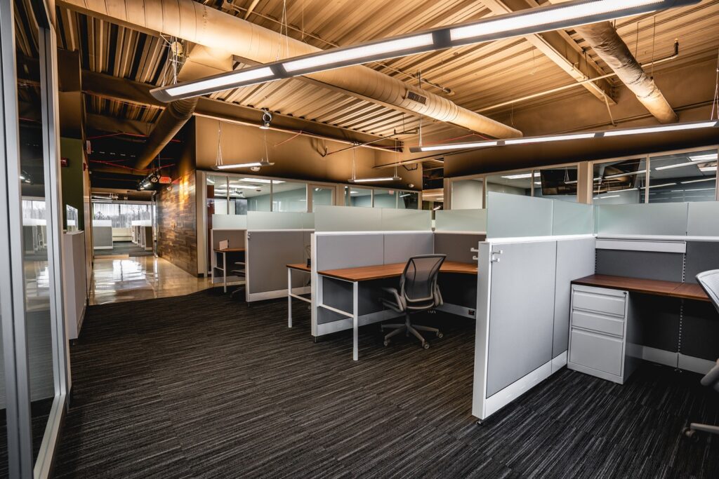 Row of workstations with partitions in an office.